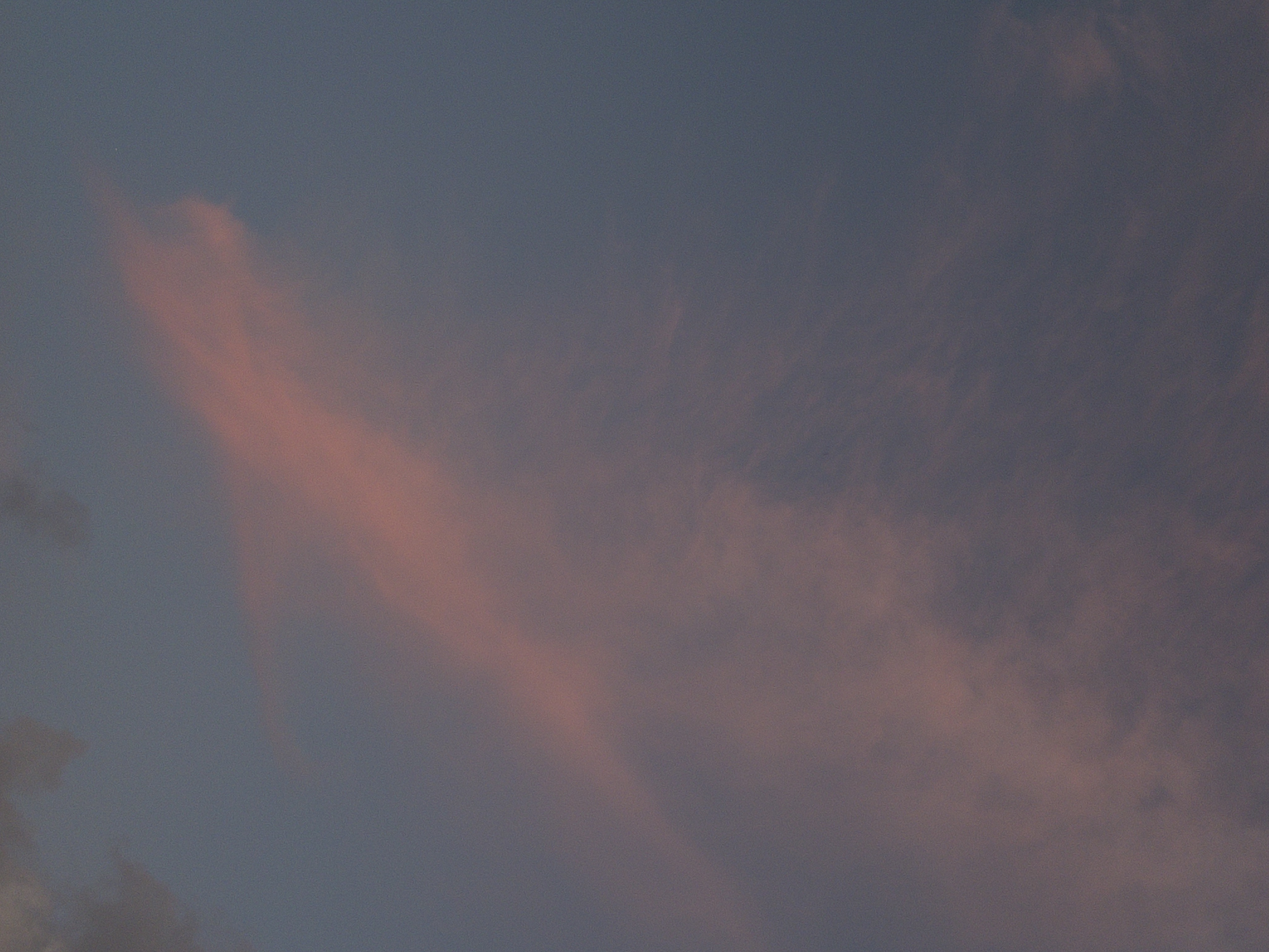 Pink and grey clouds in a twilight sky.